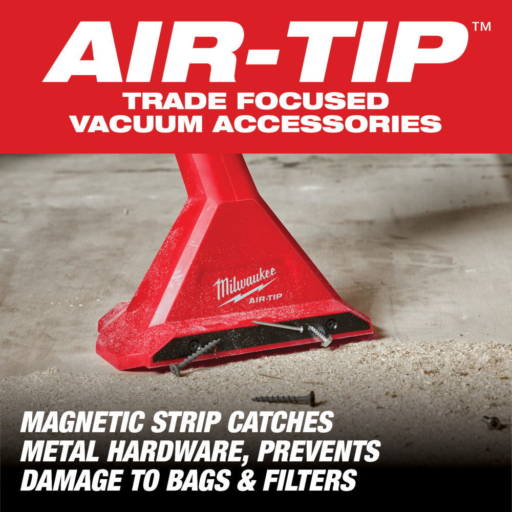 Red Milwaukee AIR-TIP magnetic utility nozzle with black strip attachment, shown on concrete surface.