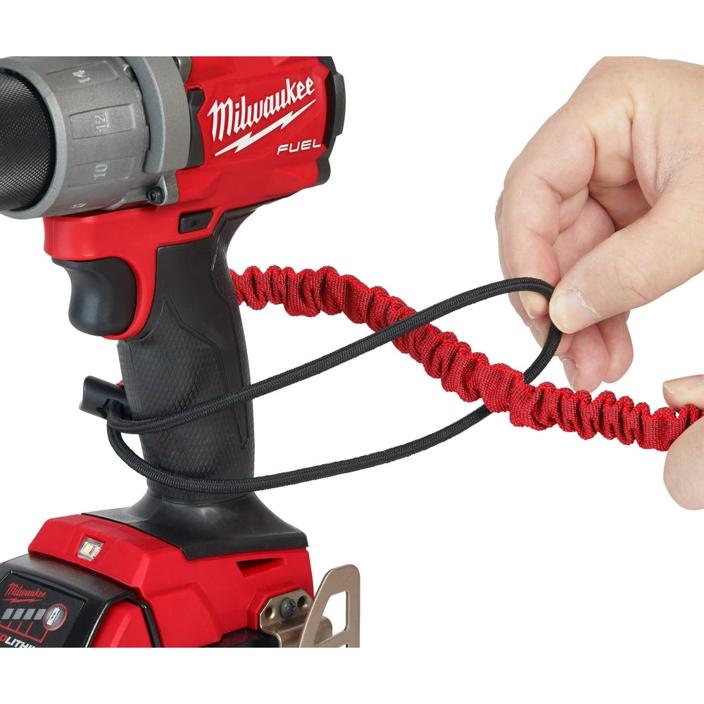 Red and black coiled lanyard with metal attachment point, connected to red Milwaukee power drill.