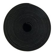 Black non-slip strip with concentric circular grooves, coiled into a roll with center hole visible.