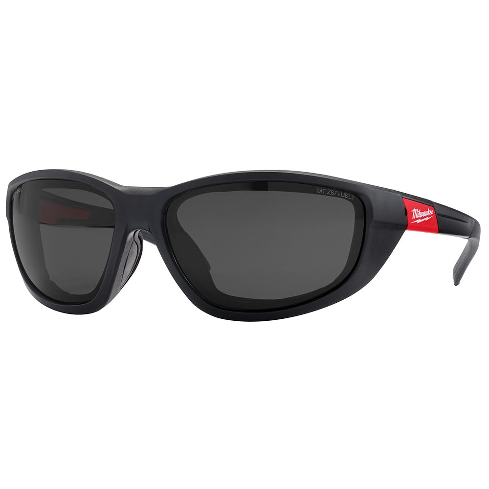 Black wraparound safety glasses with dark polarized lenses, foam gasket seal, and red Milwaukee branding on temples.