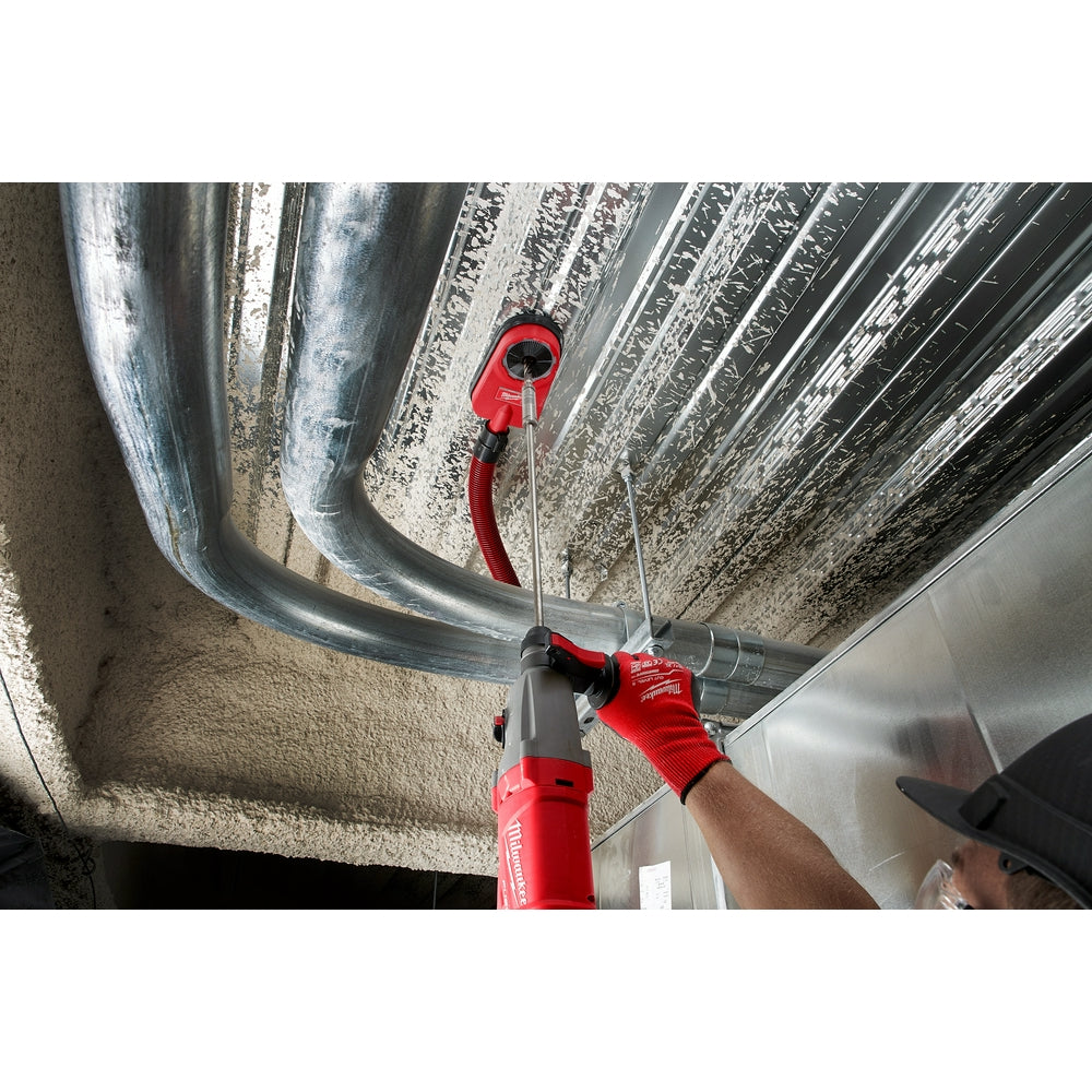 Red Milwaukee SDS+ extension rod with PLUSLOK connector being used overhead on a drilling application.