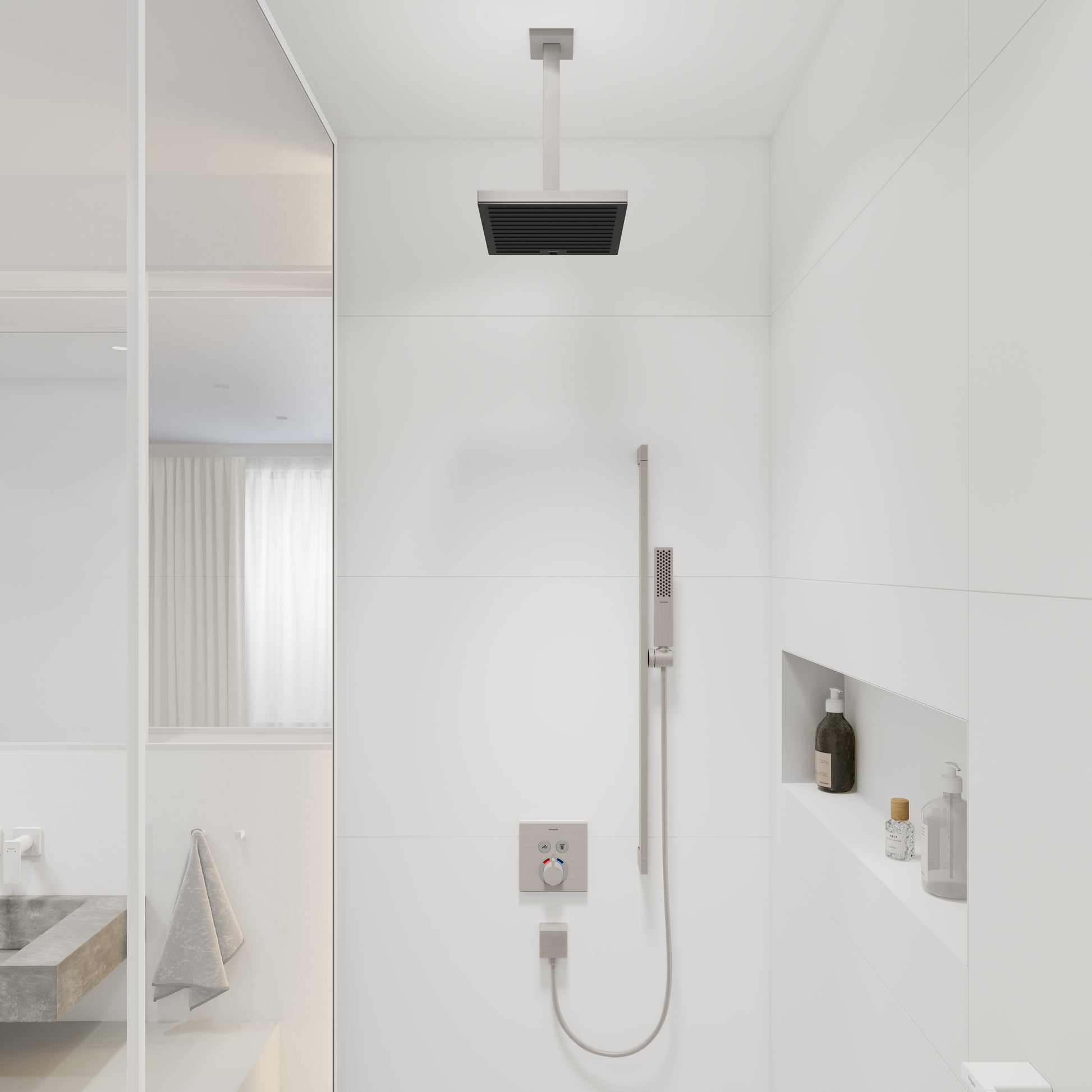 Brushed nickel extension pipe mounted to ceiling above shower head with rectangular trim plate.