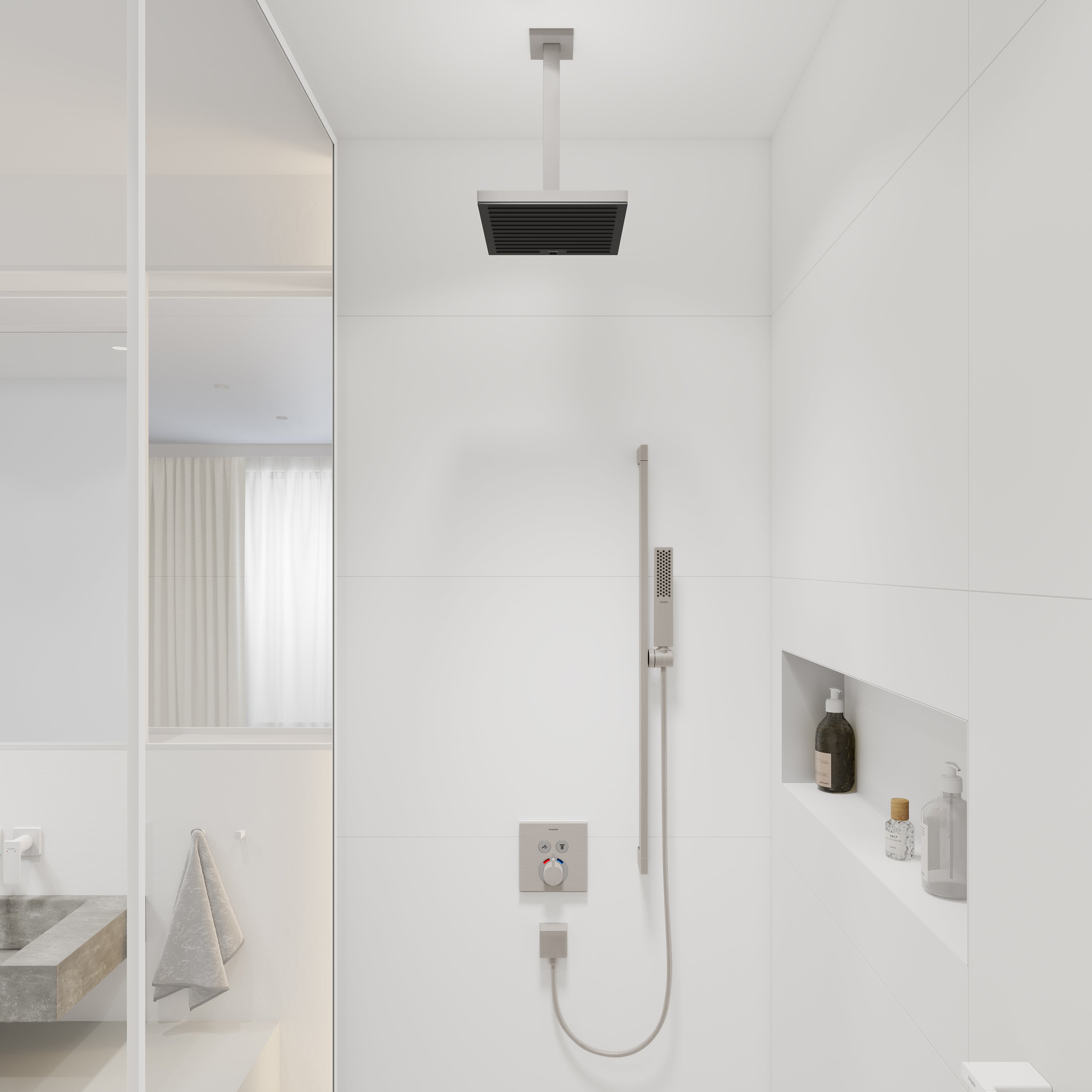 Brushed nickel extension pipe mounted to ceiling above shower head with rectangular trim plate.