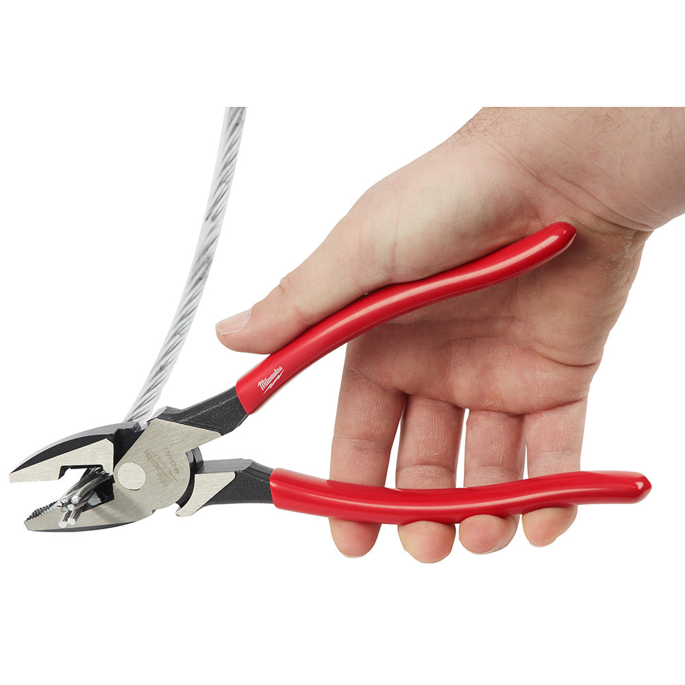Linesman's pliers with red dipped handles held in hand, showing metal head with cutting jaws and serrated gripping surfaces.