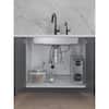 White vanity cabinet with two-door storage and single faucet sink setup.