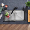 Foldable drying mat with gray fabric surface and metal frame, displayed on wooden floor.