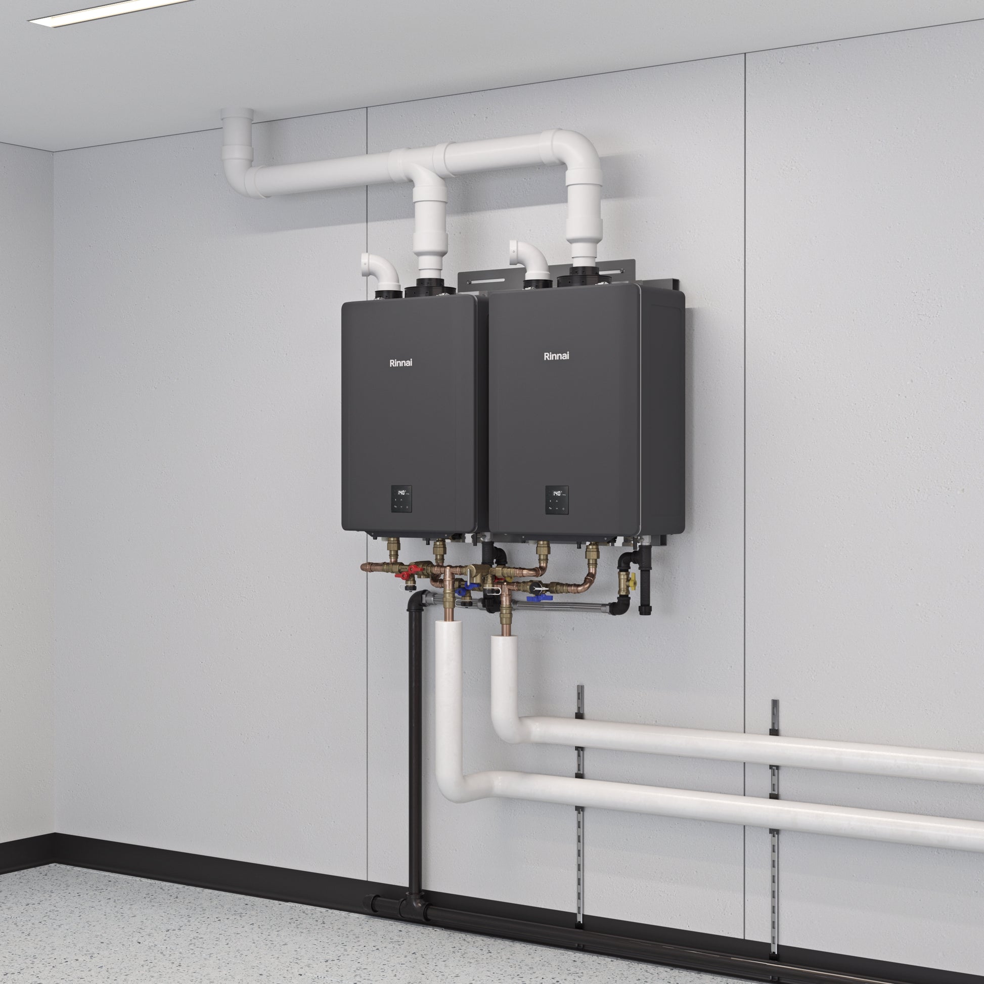 Two black Rinnai tankless water heaters mounted on wall with white PVC pipes and brass fittings below.
