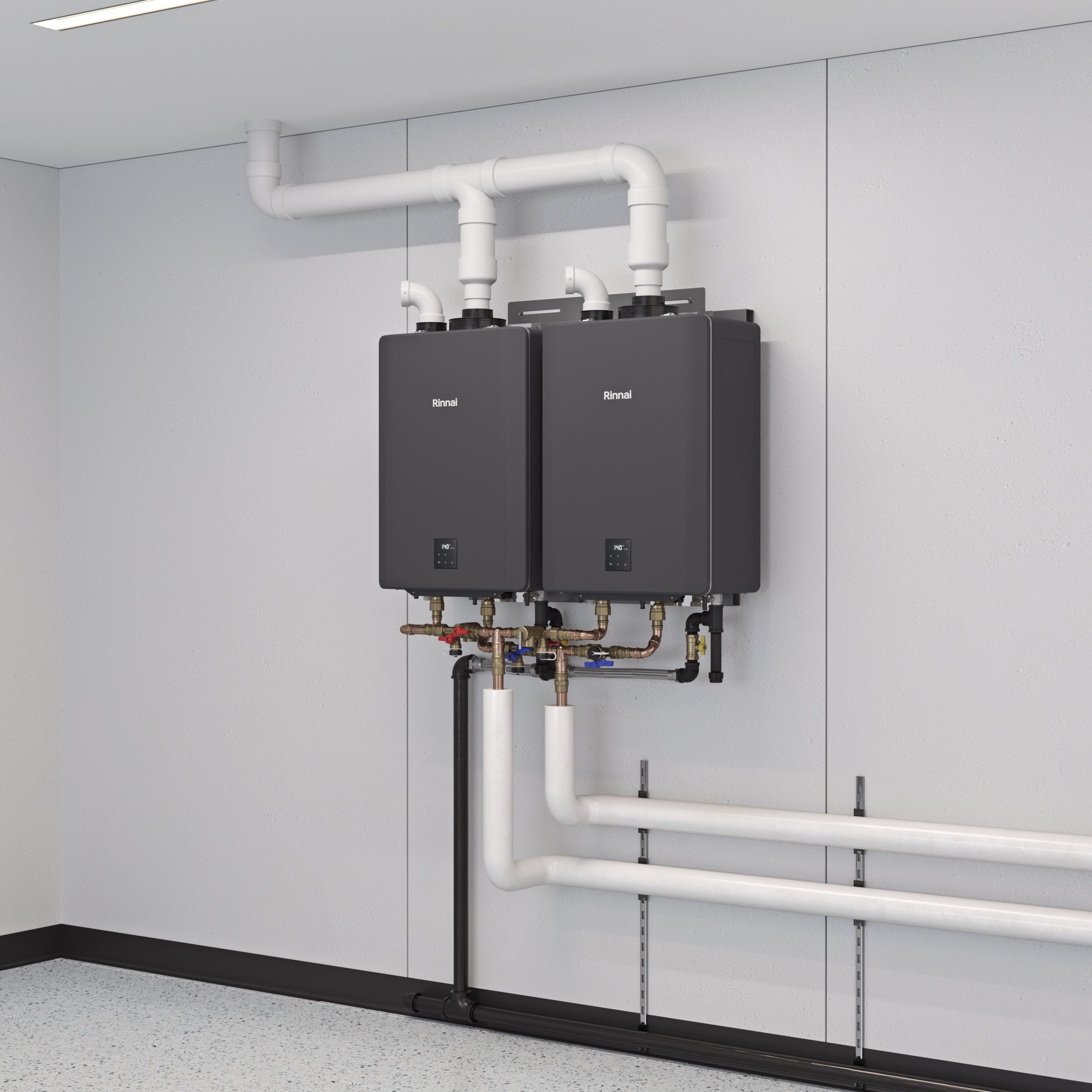 Two black Rinnai tankless water heaters mounted on wall with white PVC pipes and brass fittings below.