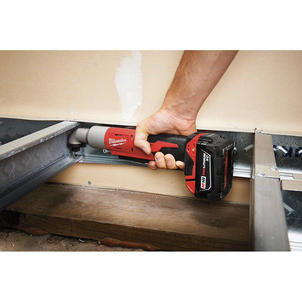 Red and black Milwaukee M18 right angle impact driver held by a person driving a screw into metal framing.