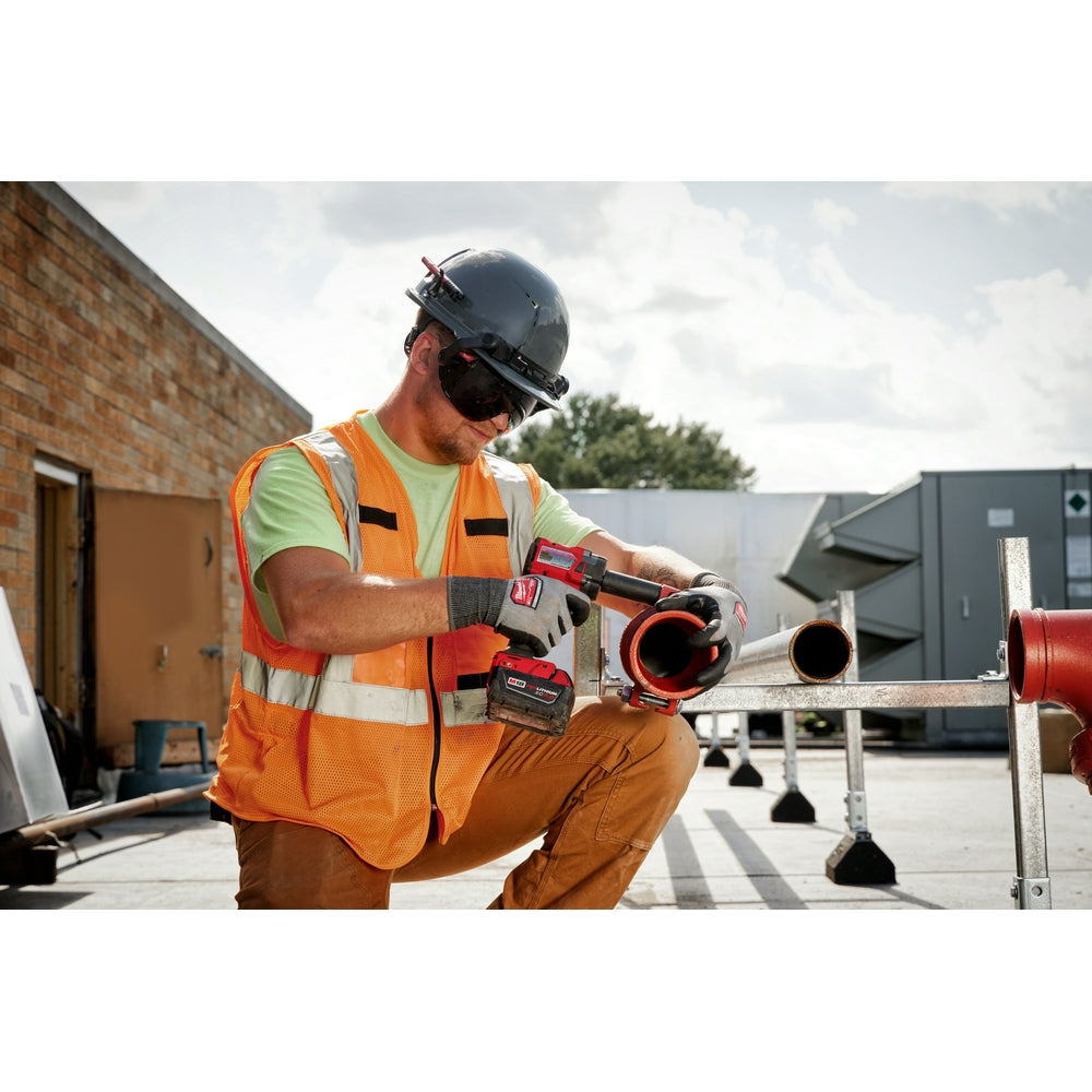 Worker wearing hard hat with dark tinted eye visor lens attached to safety helmet.