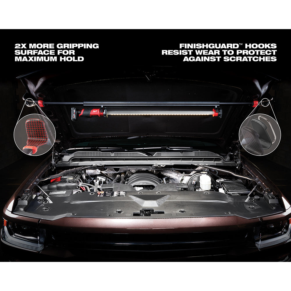 Milwaukee M12 LED underhood light mounted horizontally above engine bay with red hooks on both ends.