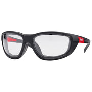Black safety glasses with clear lenses, red accents on temples, and padded gasket around frames.