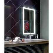 Rectangular lighted mirror with white LED border frame mounted above bathroom vanity counter with towels and accessories.