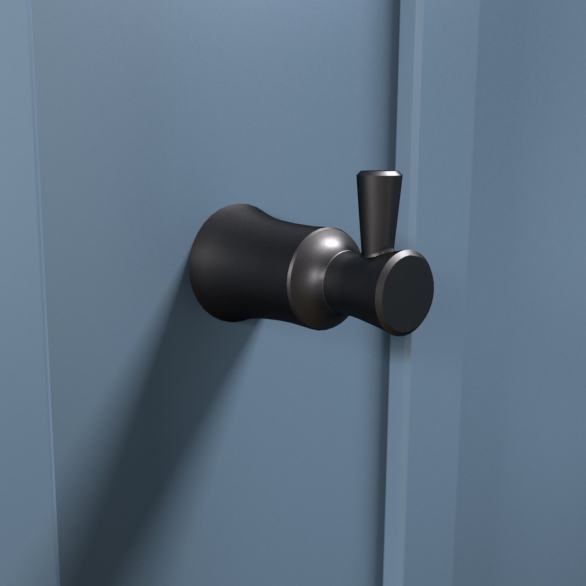 Matte black wall-mounted hook with cylindrical and rounded forms, featuring metallic accents.