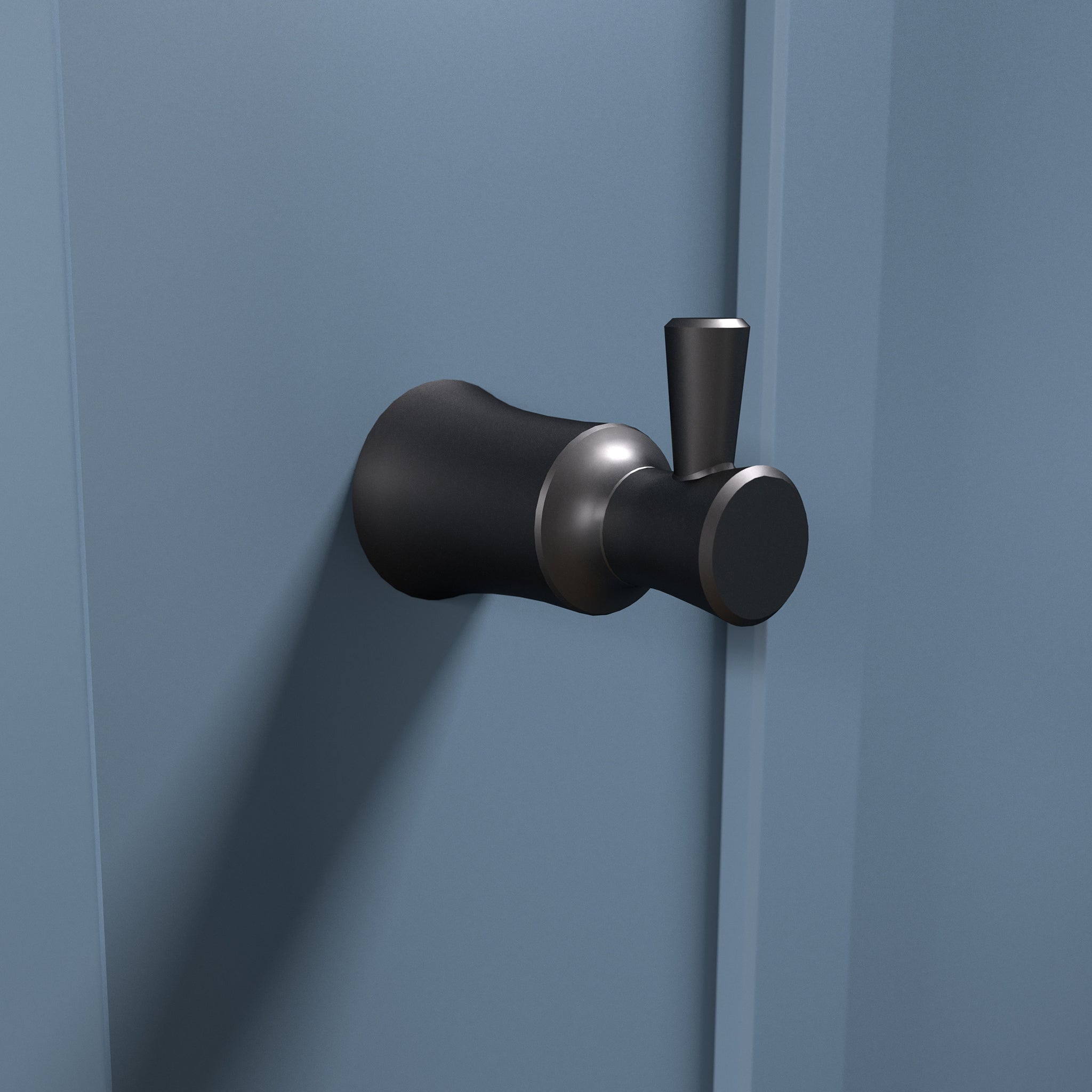 Matte black wall-mounted hook with cylindrical and rounded forms, featuring metallic accents.