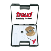Freud RP1000 panel raising cutter kit with tan router bit, small metal component, white plastic guides, metal shaft, and red 
