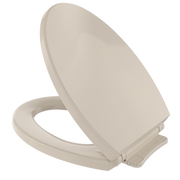 Bone-colored elongated toilet seat and lid with closed lid in raised position.