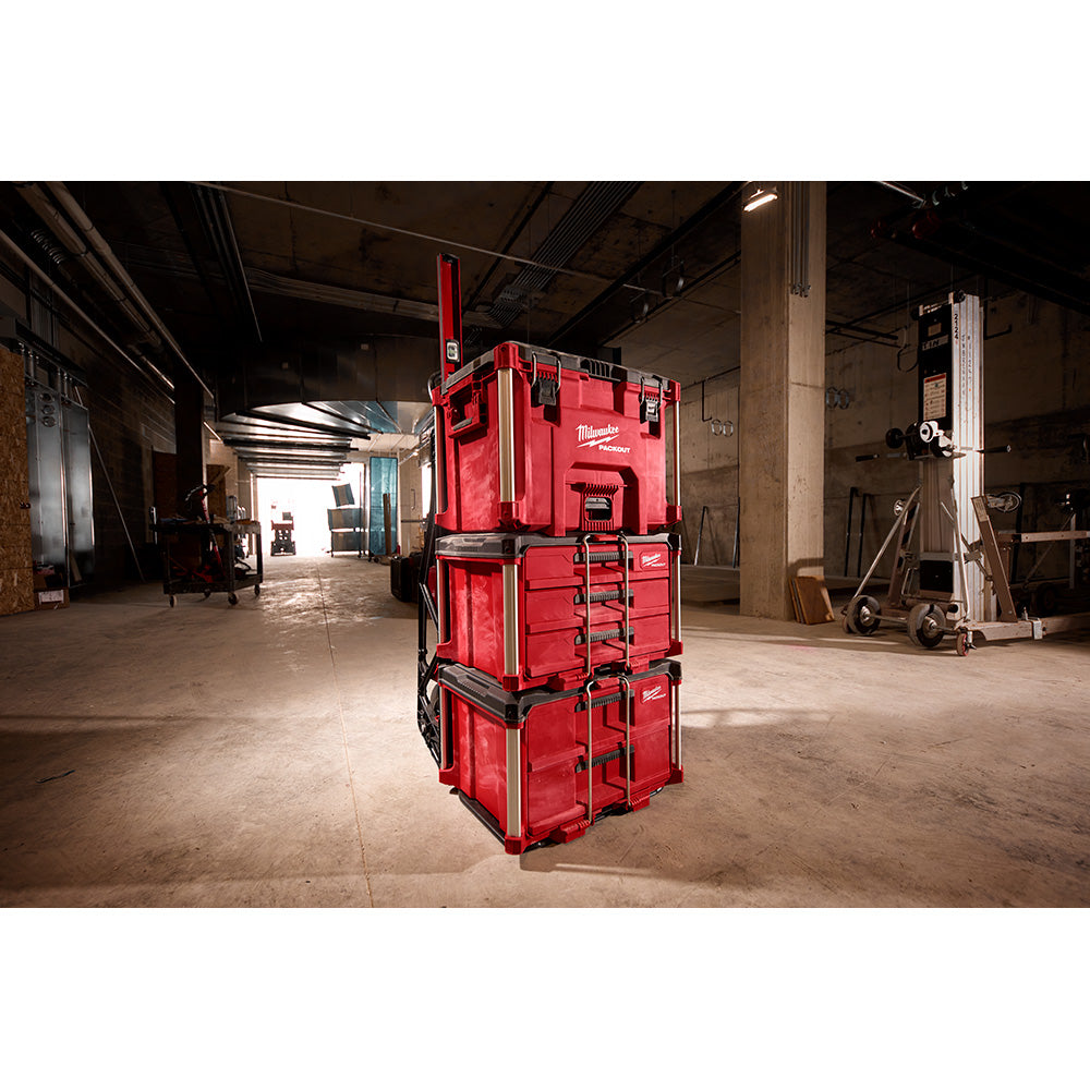 Red Milwaukee PACKOUT 3-drawer tool box stacked in modular sections with pull handle on top.