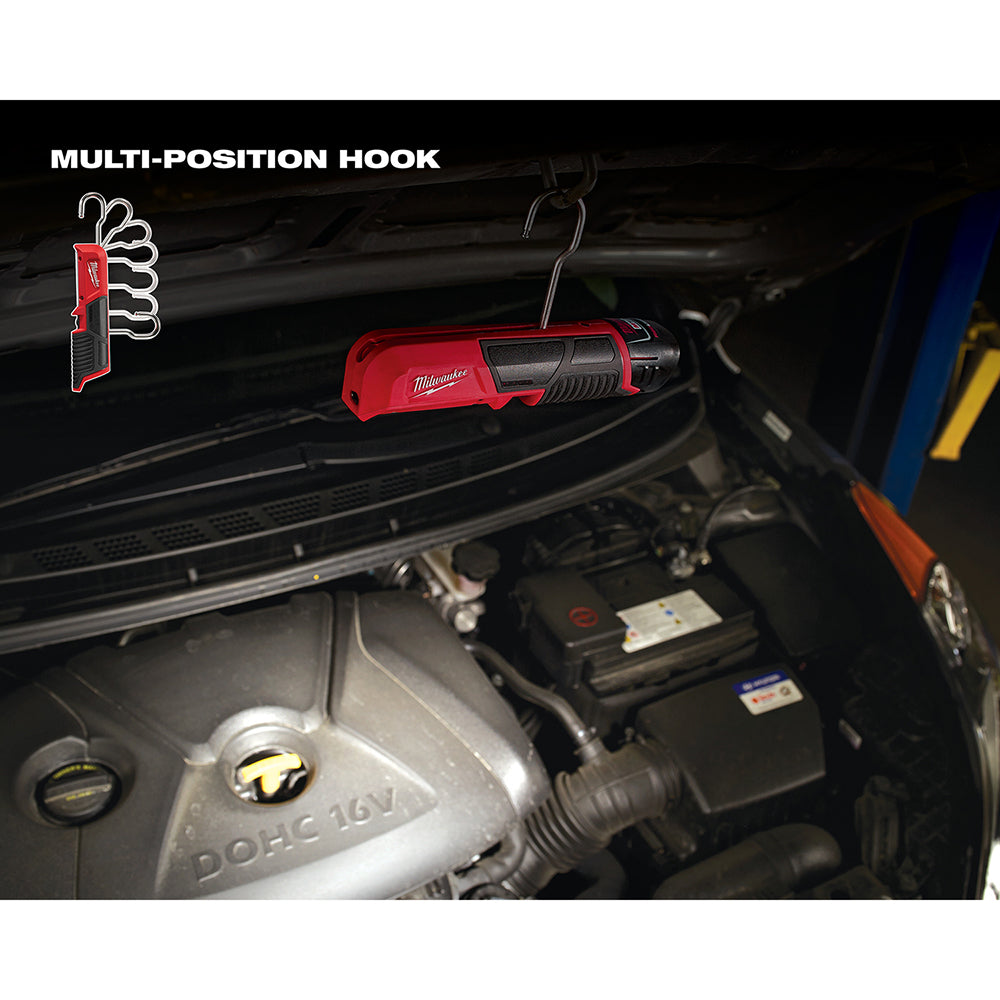 Red and black Milwaukee M12 LED stick light with multi-position hook suspended in vehicle engine bay.