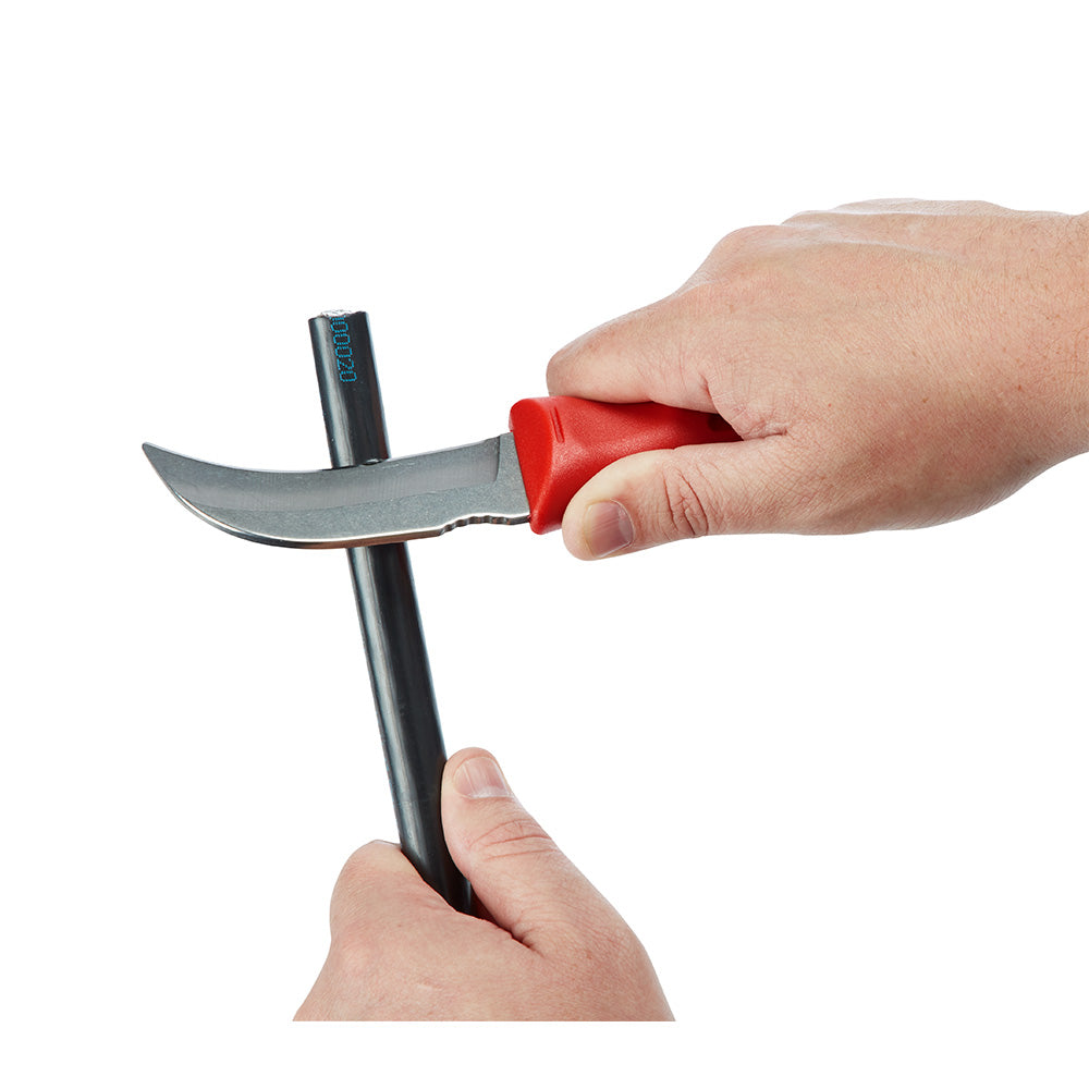 Milwaukee hawkbill fixed blade knife with red handle held in hand, showing curved gray blade.