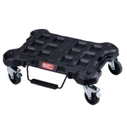 Black Milwaukee PACKOUT dolly with multiple compartments, four swivel casters, and folding handle for tool storage transport.