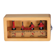 Freud 91-103 five router bits with red handles and black shanks in tan wooden case with labeled compartments.