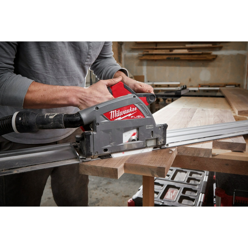 Milwaukee 31" aluminum guide rail with red and gray housing attached to power tool on wooden workbench.