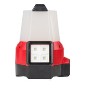 Red and black compact site light with four LED bulbs and translucent white upper housing with black top handle.