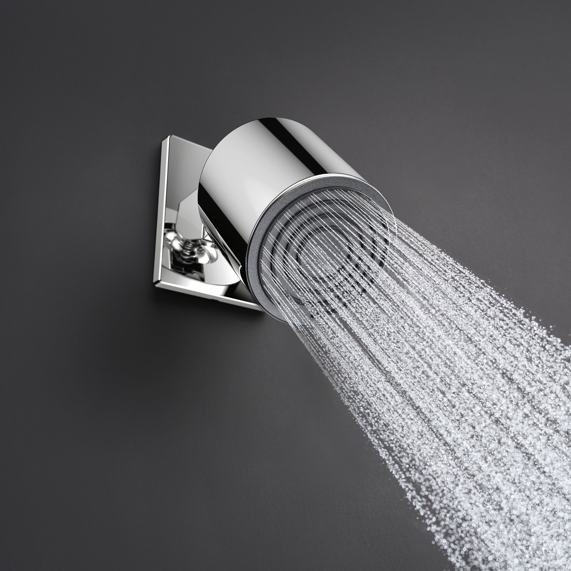 Brushed nickel cylindrical shower head with single jet mounted on square wall bracket, dispensing water stream.
