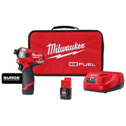 Red and black Milwaukee M12 FUEL Surge hydraulic driver with two batteries, charger, and red carrying bag.