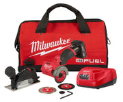 Milwaukee M12 FUEL compact cut off tool kit with red carrying bag, red tool, charger, batteries, cutting wheels, and accessor