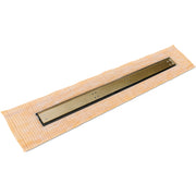 Satin bronze linear drain with black frame on tan tile substrate, shown at angle.
