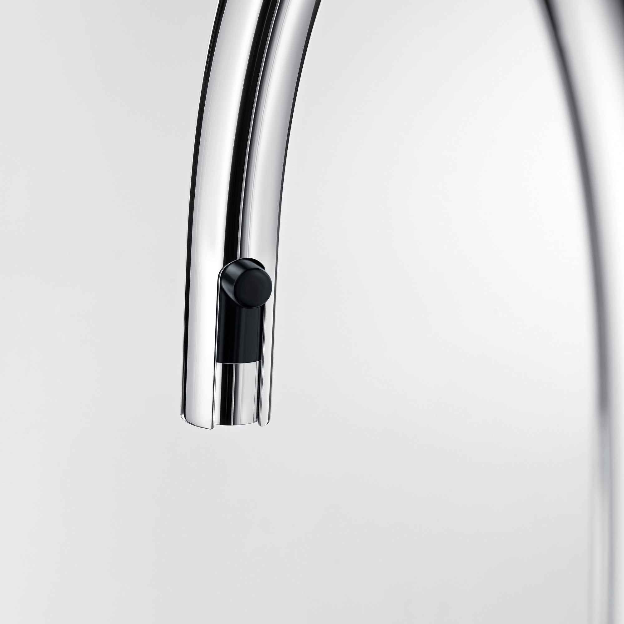 Chrome kitchen faucet with pull-down spray head and black control button.