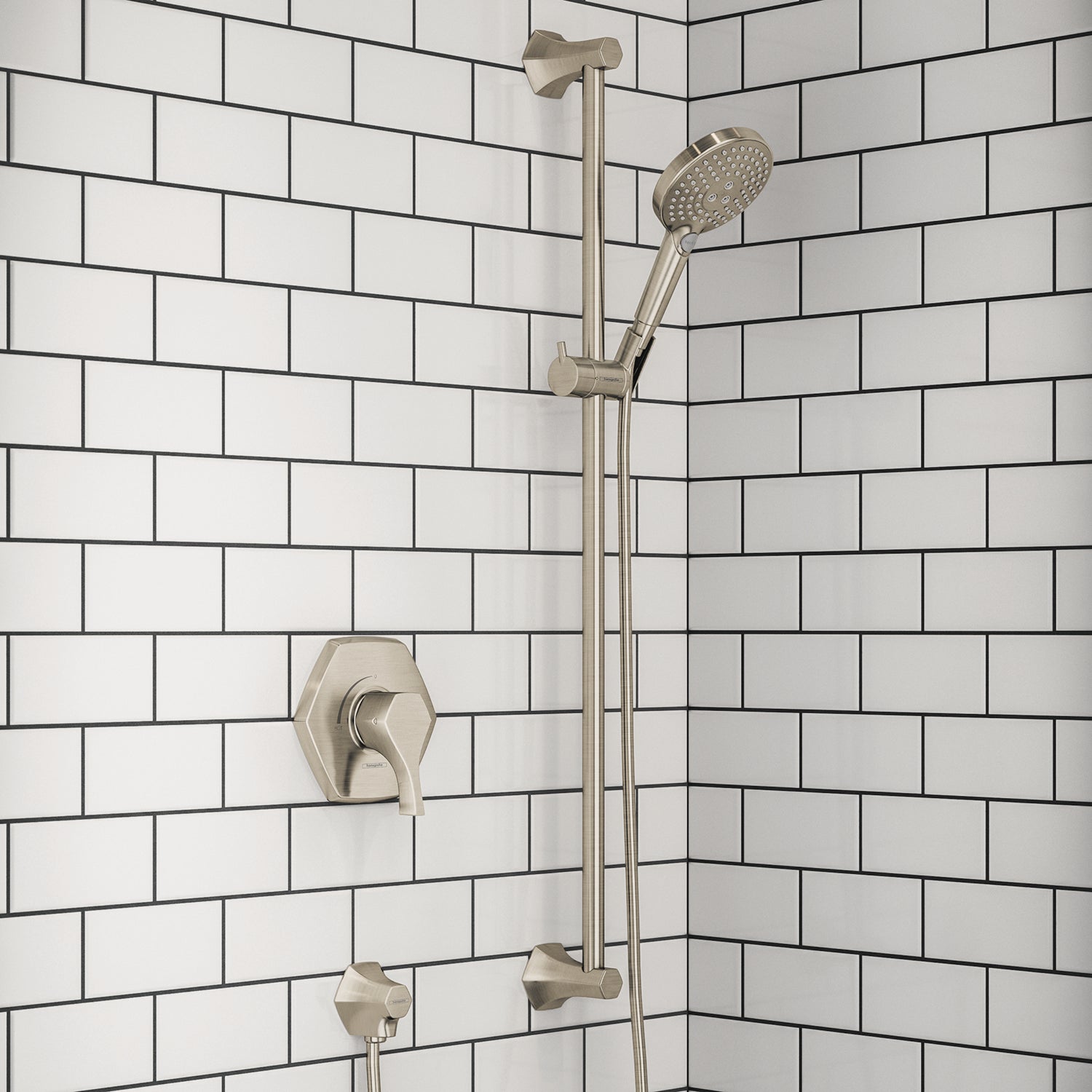 Brushed nickel shower system with wall-mounted valve, vertical bar, and handheld showerhead mounted on white subway tile wall