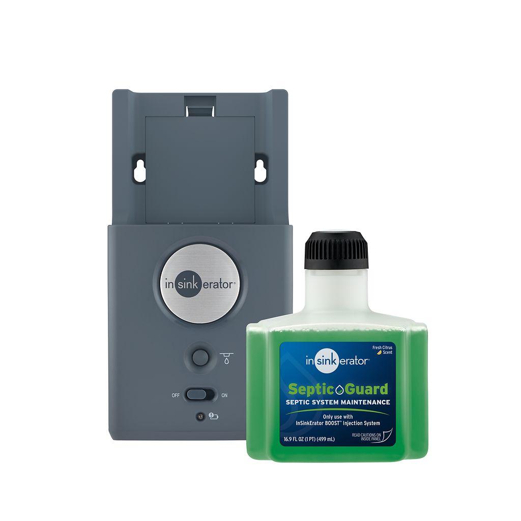 Gray InSinkErator injection system dispenser with stainless steel circular logo and green SepticGuard refill bottle with blac