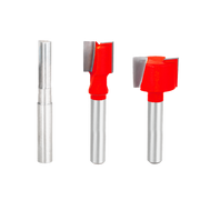 Three router bits with 1/4" shanks: one straight flute bit and two red plywood cutting bits with carbide tips.