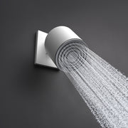 Brushed nickel shower arm with cylindrical head angled downward, dispensing water spray against gray background.