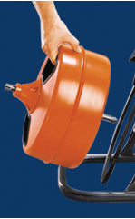 Orange drum-style cable machine with handle and attached black cord on blue background.