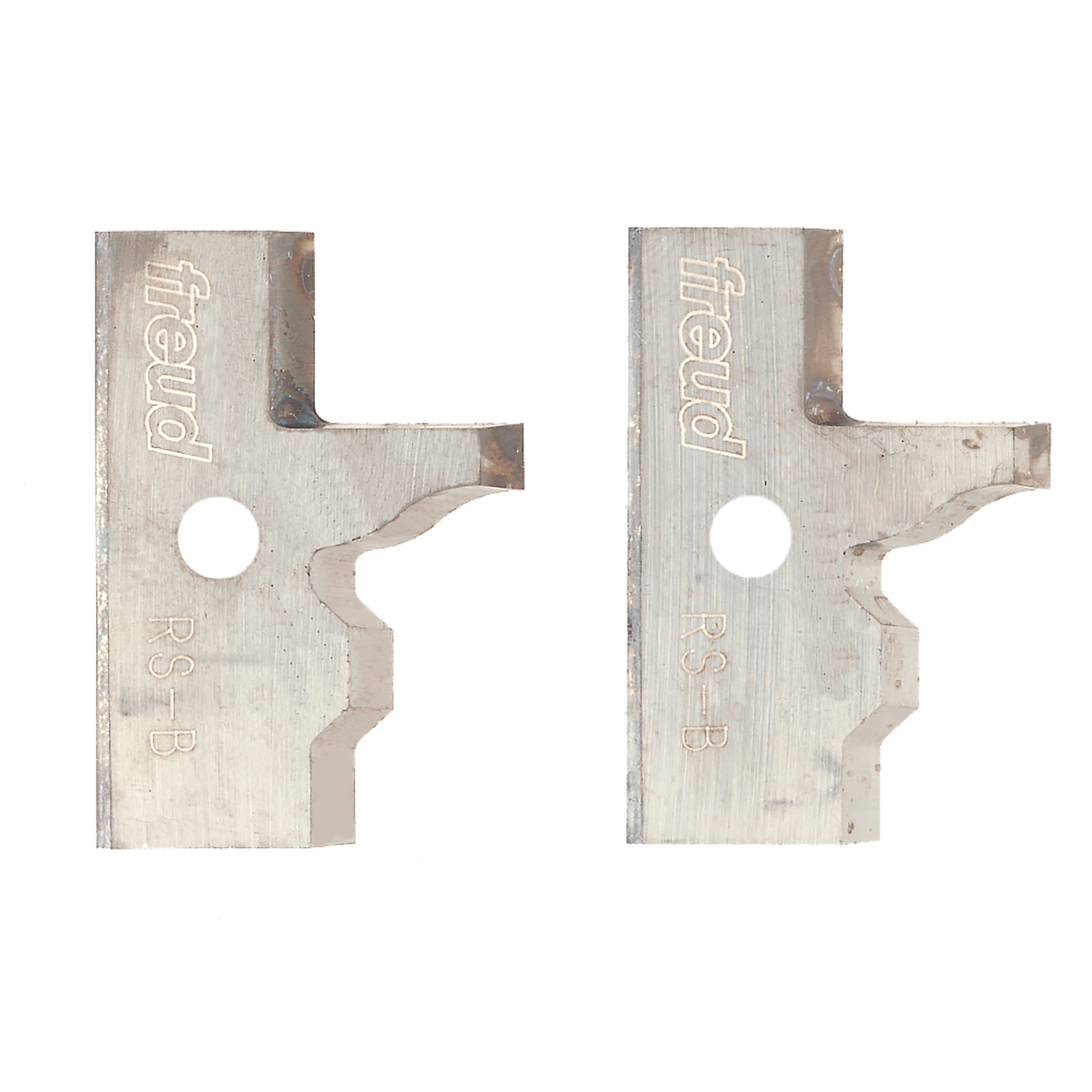 Two metal router knives with Freud branding, curved cutting edges, and mounting holes for rail and stile profiling.