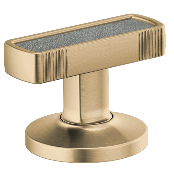 Brass faucet handle with concrete inlay top and vertical ribbed detailing on cylindrical base.