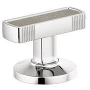 Chrome bathroom faucet handle with concrete inlay top and vertical ribbed sides on circular base.