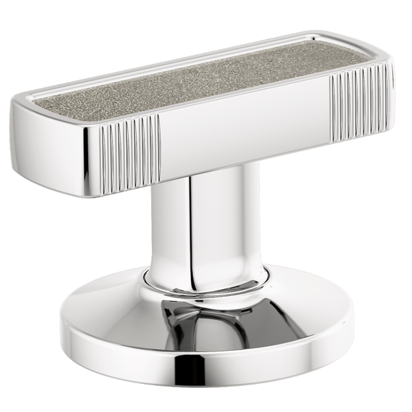 Chrome bathroom faucet handle with concrete inlay top and vertical ribbed sides on circular base.