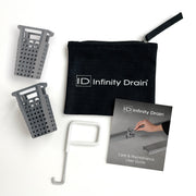 Infinity Drain drain maintenance kit containing two gray perforated baskets, white tool, black pouch, and care guide.