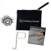 Infinity Drain HMK-T kit containing circular stainless steel grate, white removal tool, black carrying pouch, and care guide.