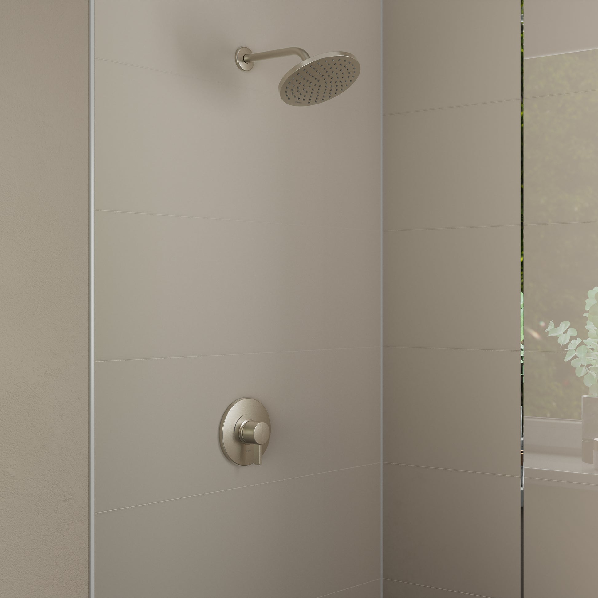 Brushed nickel shower set with round rainfall showerhead and wall-mounted pressure balance valve on tiled shower wall.