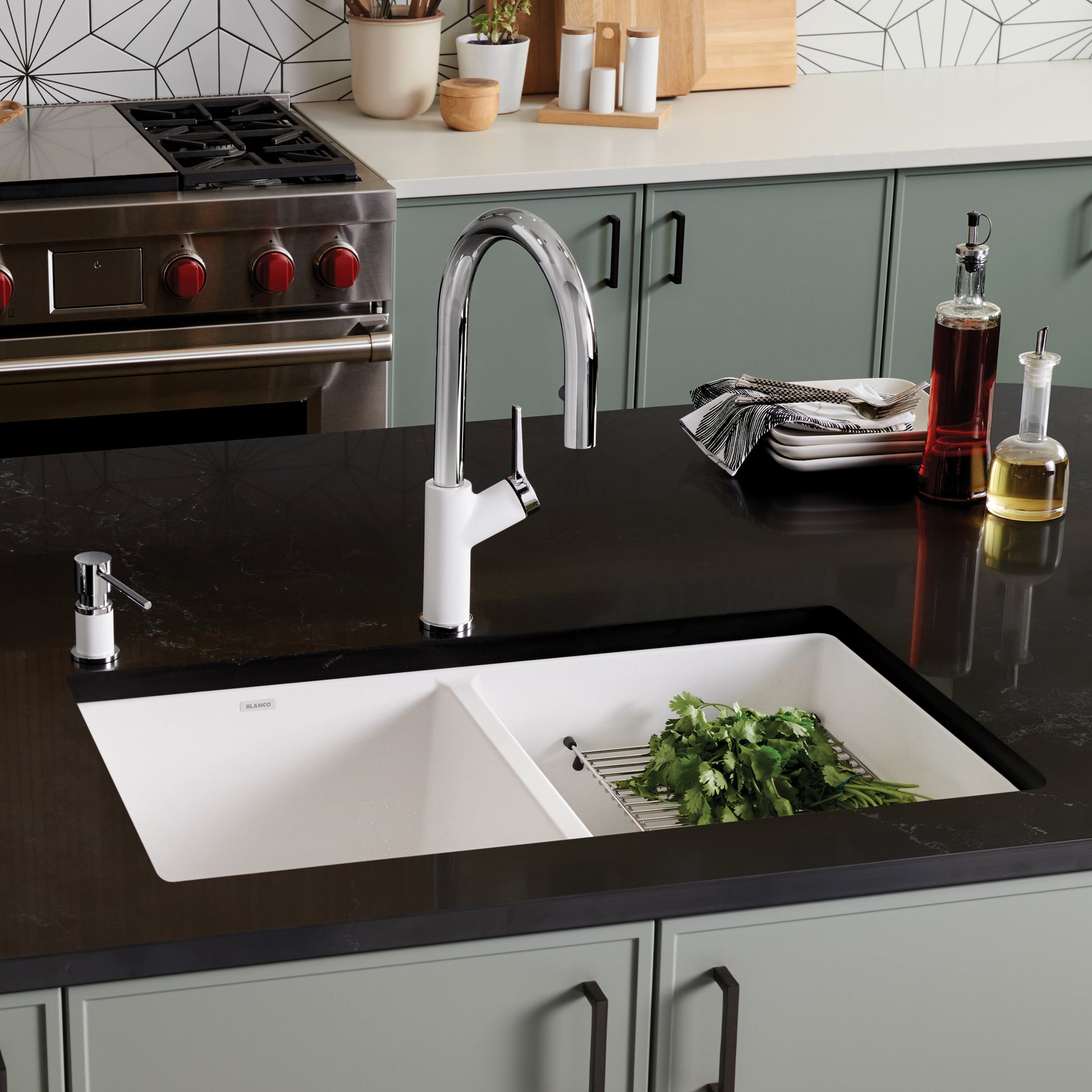 White undermount double bowl sink with equal-sized compartments and chrome faucet installed in black countertop.