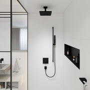 Matte black square ceiling-mounted shower head with 4-inch extension pipe on white bathroom wall.