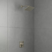 Brushed nickel shower system with square overhead showerhead and wall-mounted pressure balance valve on tiled shower wall.