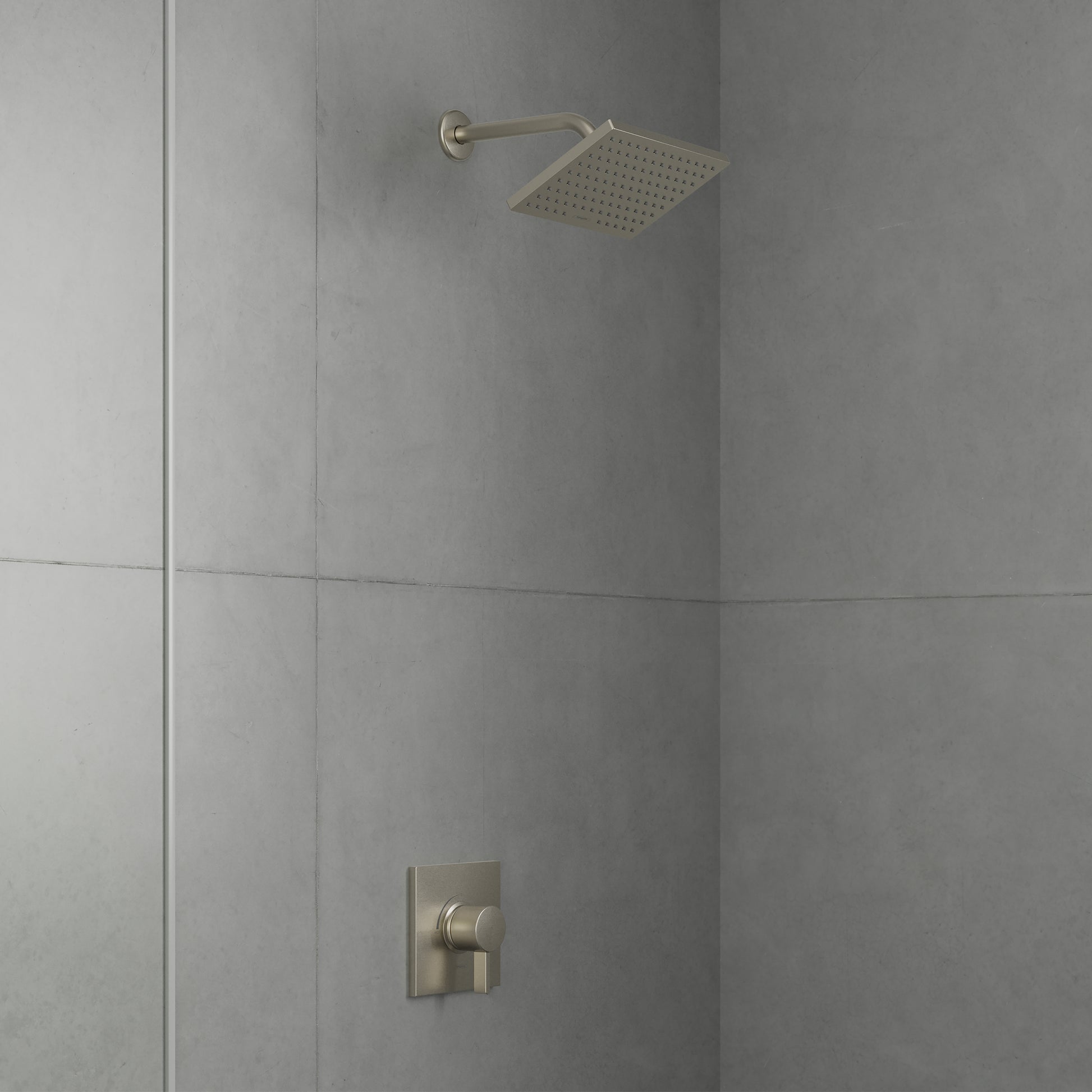Brushed nickel shower set with square overhead showerhead and wall-mounted pressure balance valve on tiled bathroom wall.