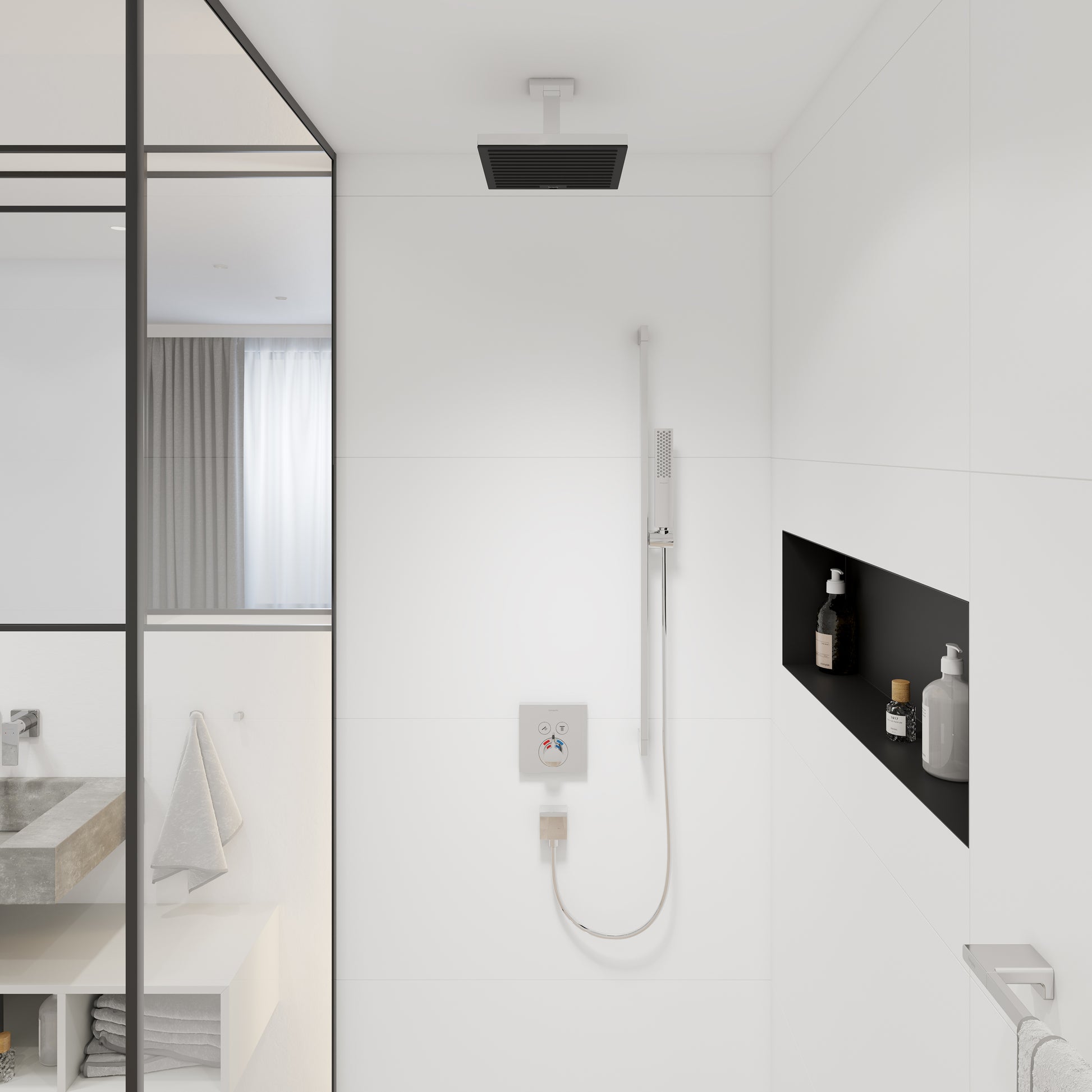 Chrome ceiling-mounted shower extension pipe with black rectangular showerhead installed above white tile wall.